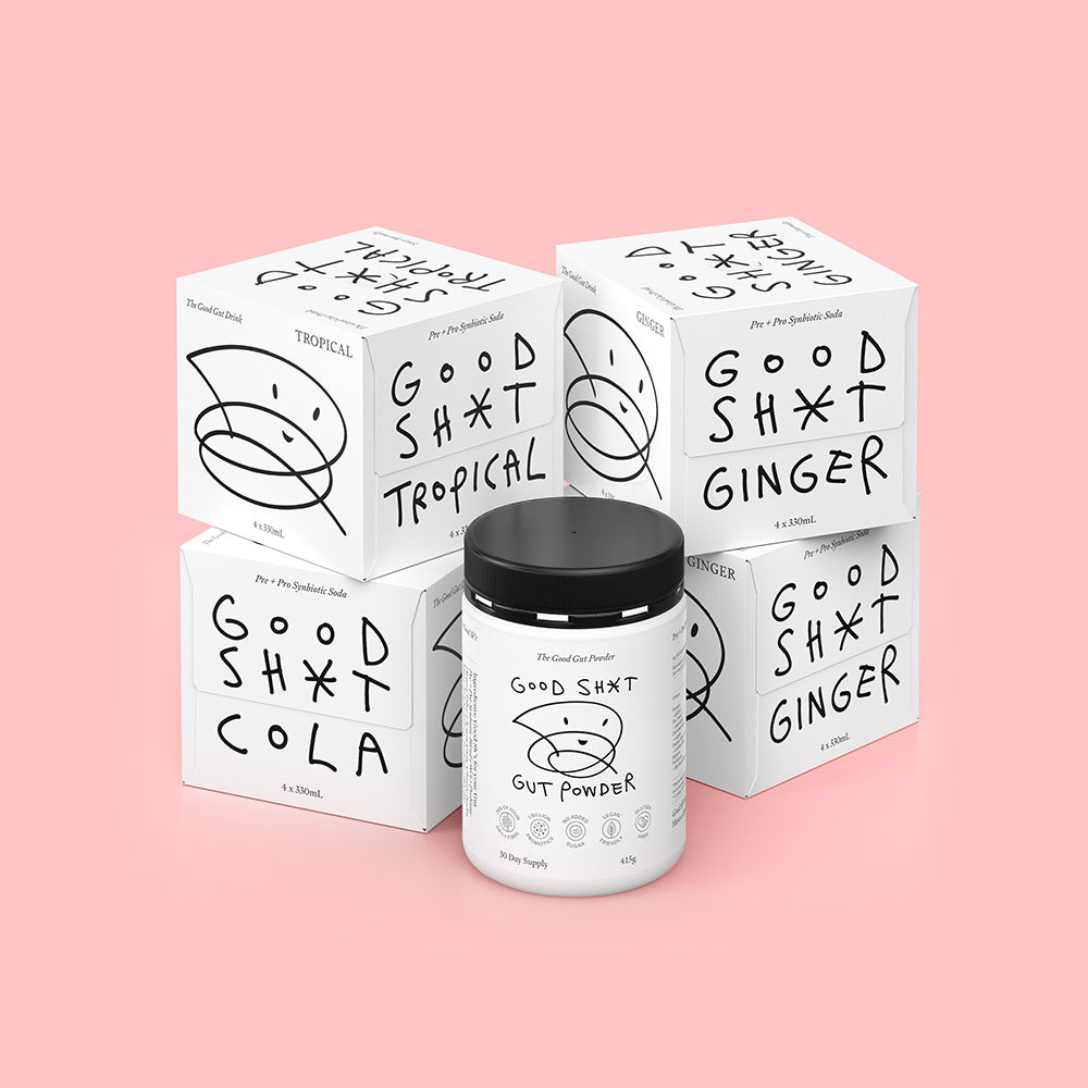 A stack of four 4 pack boxes of Good Shit pre + probiotic soda. One box each of cola and tropical flavours, two boxes of ginger plus a tub of Good Shit pre + probiotic Gut Powder, containing enough powder for 30 days