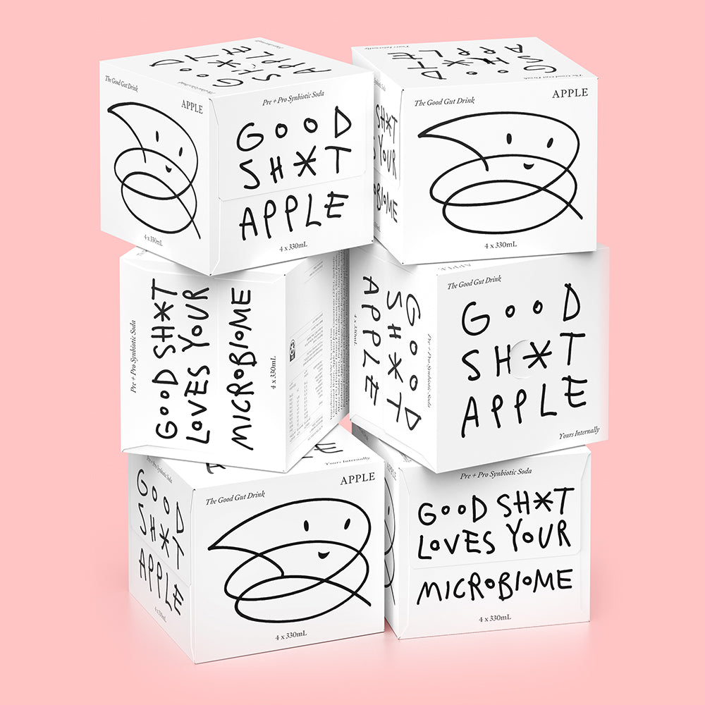 A stack of six 4 pack boxes of Good Shit apple pre + probiotic soda