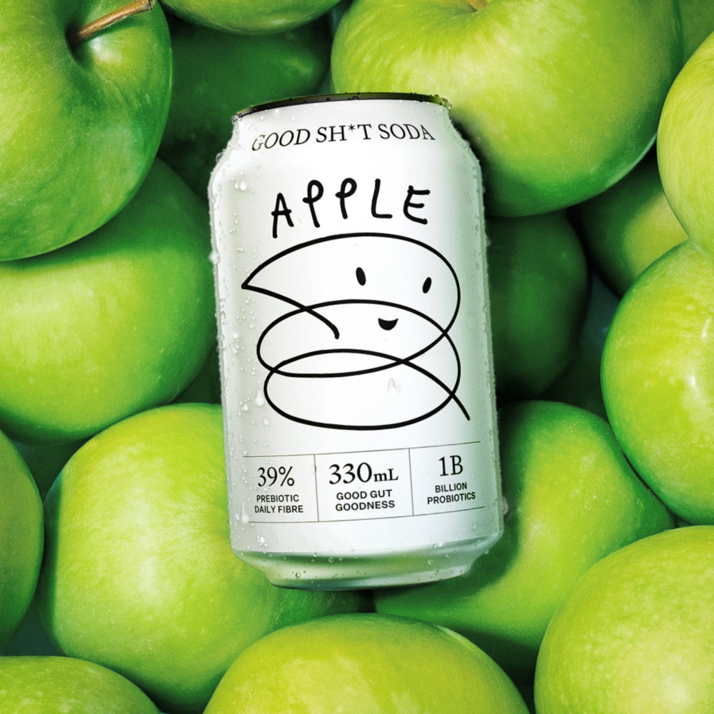 Can of 'Good Sh*t Soda Apple' surrounded by green apples