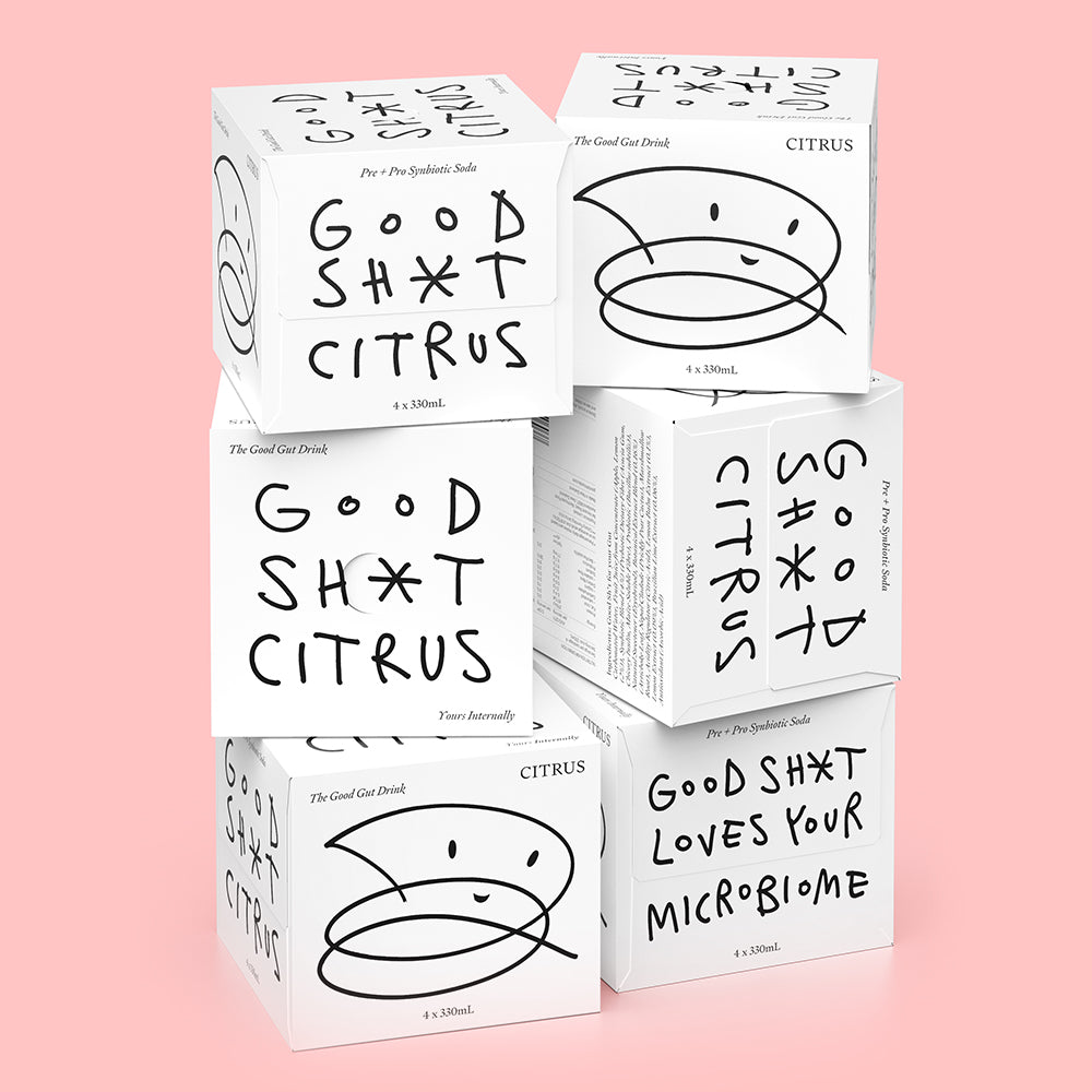A stack of six 4 pack boxes of Good Shit citrus pre + probiotic soda